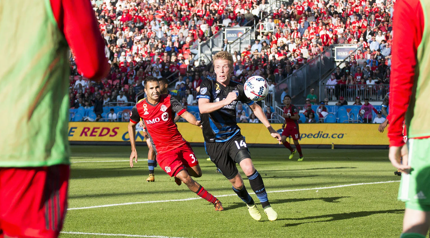 Steven Betiashour trying to get the ball from a defender shot between Toronto FC subsitutues. 