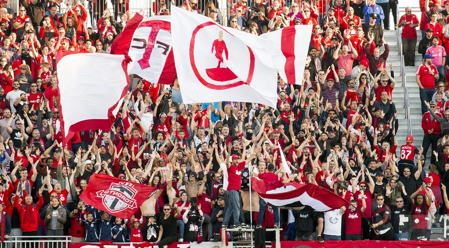 The south end supporter's section goes wild over a fourth goal at BMO Field against the San Jose Earthquakes. Image by Dennis Marciniak of denMAR Media.