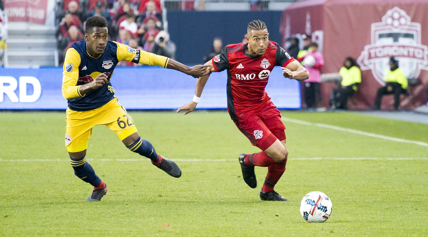 Justin Morrow gets the ball down towards the attacking half during a 2017 MLS playoff match against the New York Red Bulls. Image by Dennis Marciniak of denMAR Media.