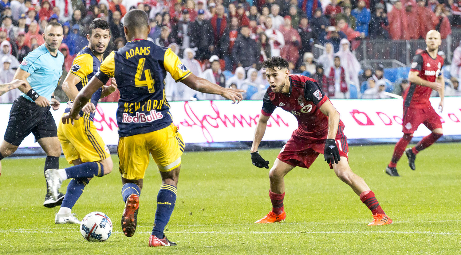 Jonathan Osorio tries to block the ball from being cleared in a Major League Soccer playoff match in 2017. Image by Dennis Marciniak of denMAR Media.
