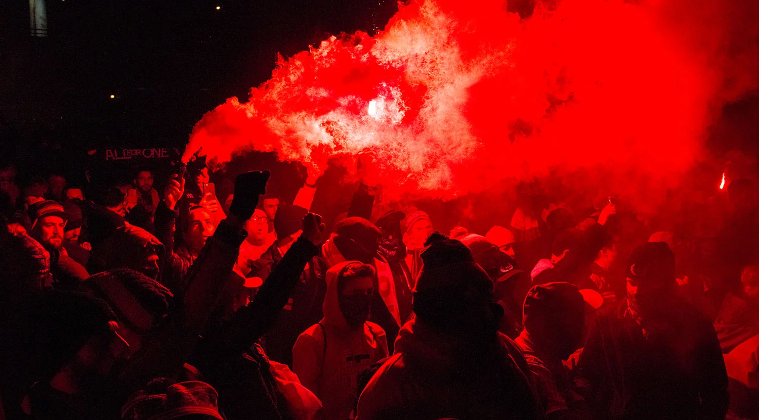 Toronto FC supporters lighting flares and smoke in front of BMO Field during that march to the match ahead of the Major League Soccer Eastern Conference Final. Image by Dennis Marciniak of denMAR Media.