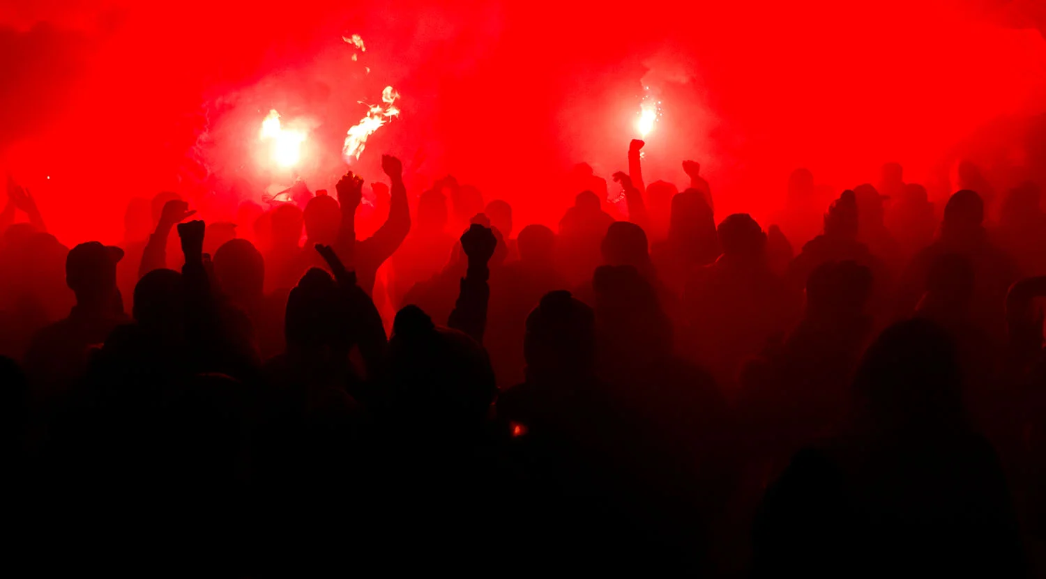 TFC supporters lighting flares and smoke in front of BMO Field during that march to the match ahead of the Major League Soccer Eastern Conference Final. Image by Dennis Marciniak of denMAR Media.
