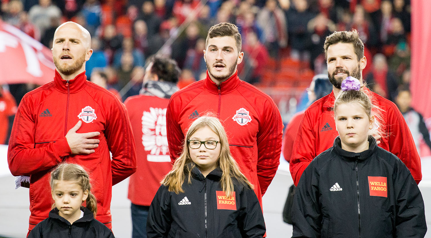Toronto FC oberserving the national anthems just ahead of kickoff during the opening ceremonies. Image by Dennis Marciniak of denMAR Media.