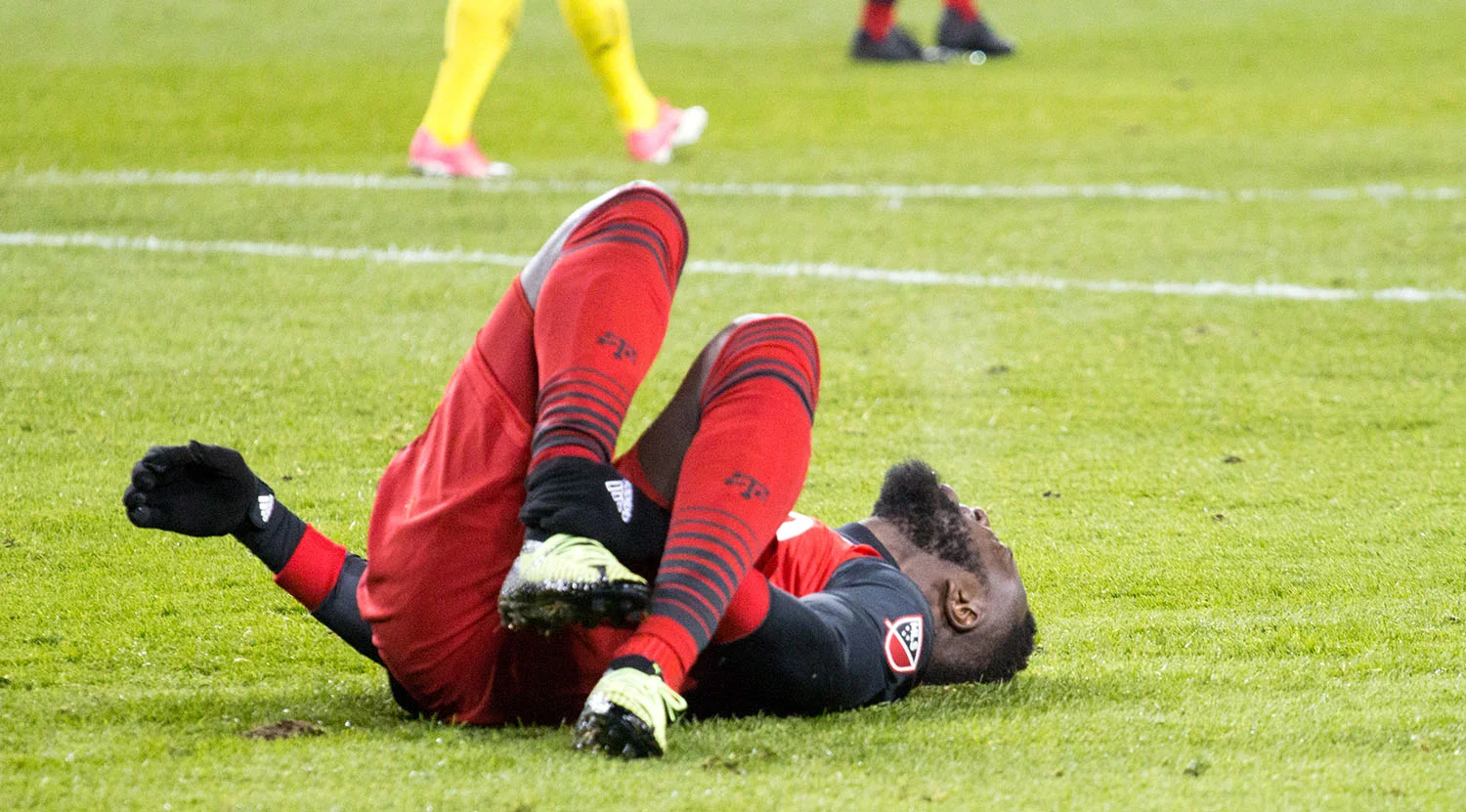 Jozy Altidore in pain on the ground due to an ankle injury. He would stay on to score the series deciding goal. Image by Dennis Marciniak of denMAR Media.
