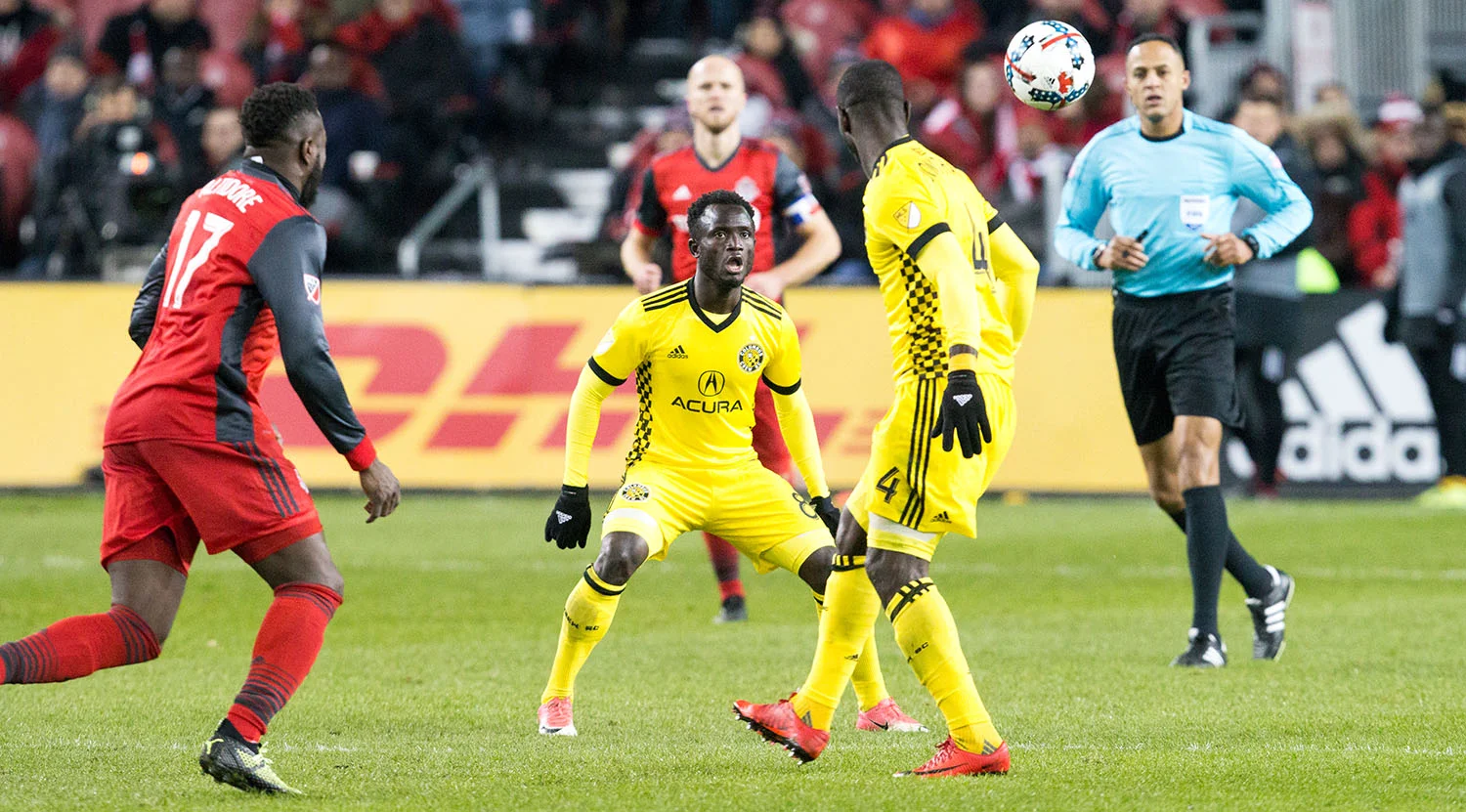Toronto FC and Columbus crew players looking to get to the ball during a MLS playoff match in 2017. Image by Dennis Marciniak of denMAR Media.