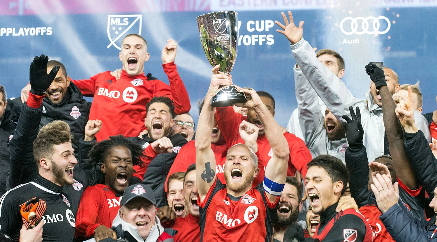 Toronto FC celebrating the advance to the 2017 Major League Soccer Finale with the Eastern Conference trophy. Image by Dennis Marciniak of denMAR Media.
