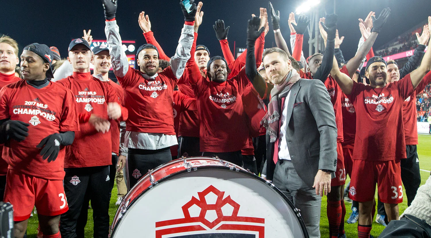Greg Vanney at the drum celebrating the Eastern Conference final win with the south end supporters groups. Image by Dennis Marciniak of denMAR Media.