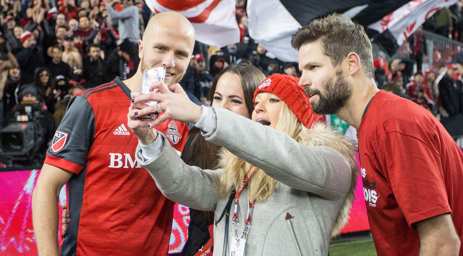 Michael Bradley and Drew Moor celebrating the Eastern Conference Final win with loved ones on the pitch at BMO Field in Toronto, Canada.