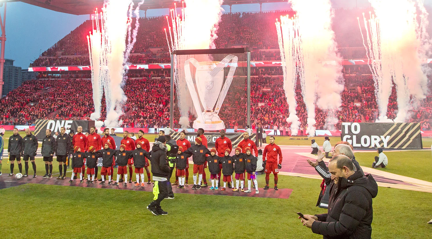 Toronto FC with Don Garber in the foreground as fireworks go off in the background during the opening ceremonies for the 2017 MLS Cup Final. Image by Dennis Marciniak of denMAR Media.