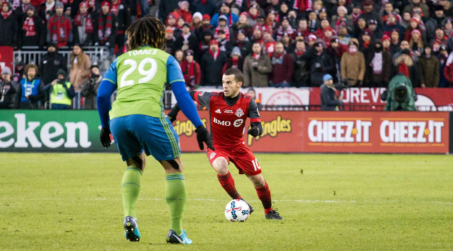 Sebastian Giovinco tries to find space with Roman Torres trying to shut down the play during the 2017 MLS Cup Final. Image by Dennis Marciniak of denMAR Media.
