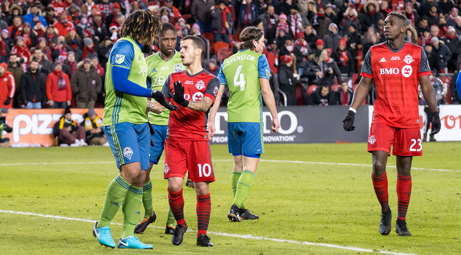 Sebastian GIovinco and Seattle Sounders' Roman Torres get into it during the second half of the MLS Cup Final on December 9, 2017. Image by Dennis Marciniak of denMAR Media.