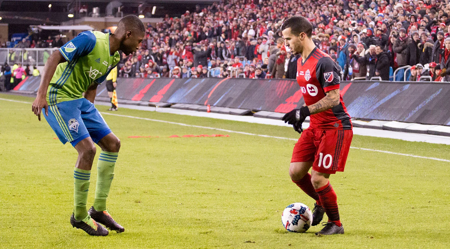 Sebastian Giovinco tries to get past another Seattle Sounder defender at BMO FIeld in 2017. Image by Dennis Marciniak of denMAR Media.