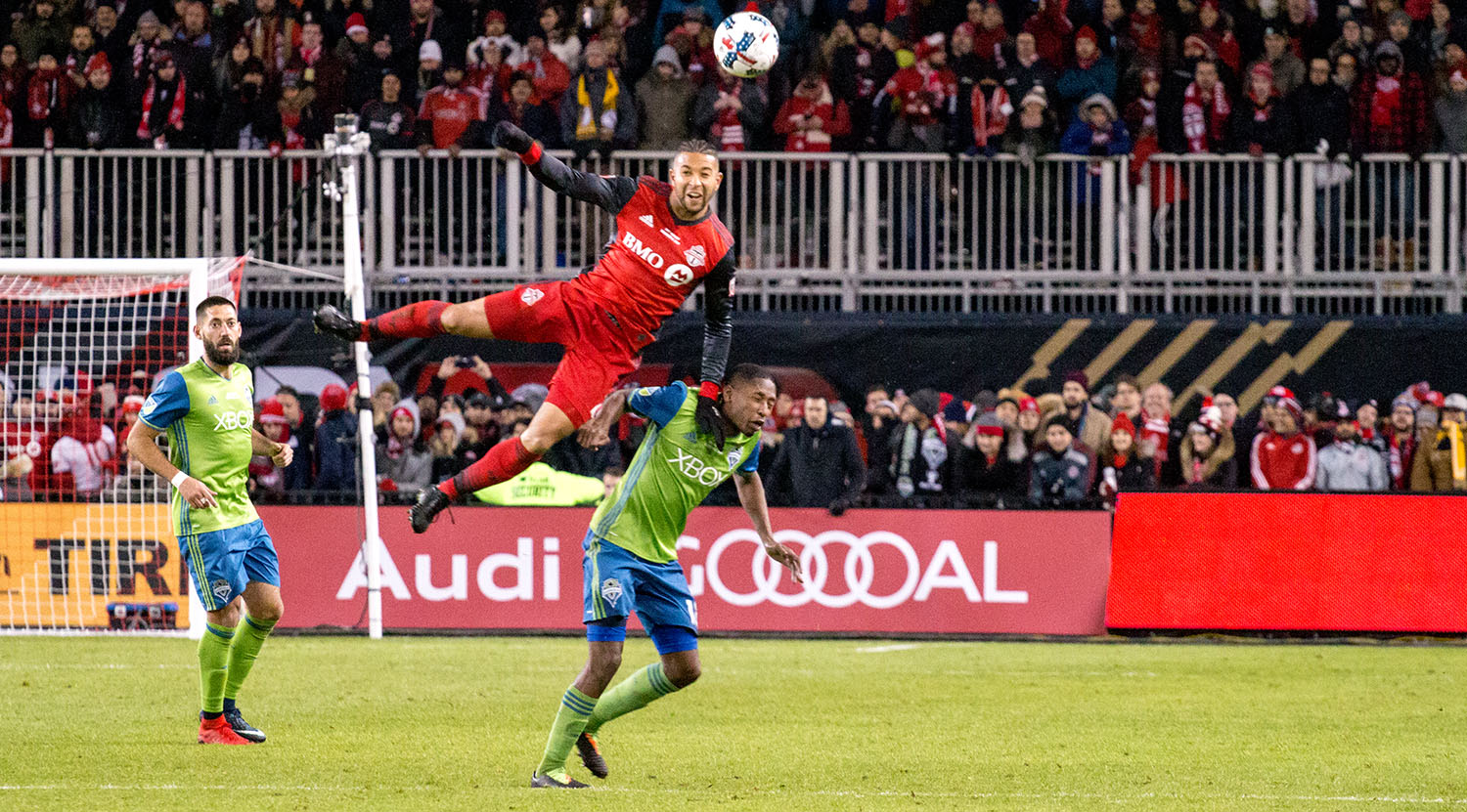 Justin Morrow takes flight during the 2017 MLS Cup Final to get a header to the ball at BMO FIeld. Image by Dennis Marciniak of denMAR Media.