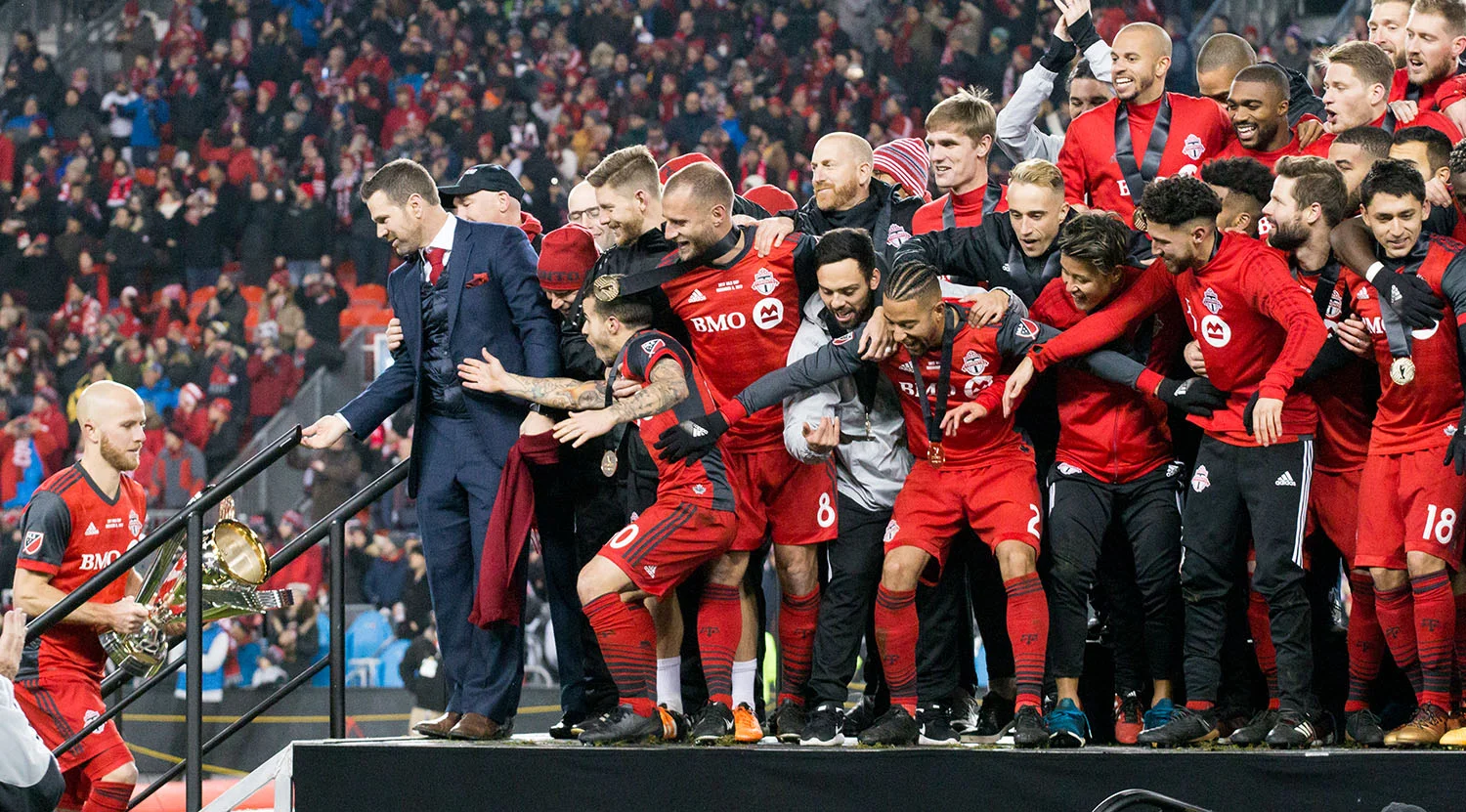 Michael Bradley taking the 2017 MLS Cup to the stage awaited by an excited Toronto FC. Image by Dennis Marciniak of denMAR Media.