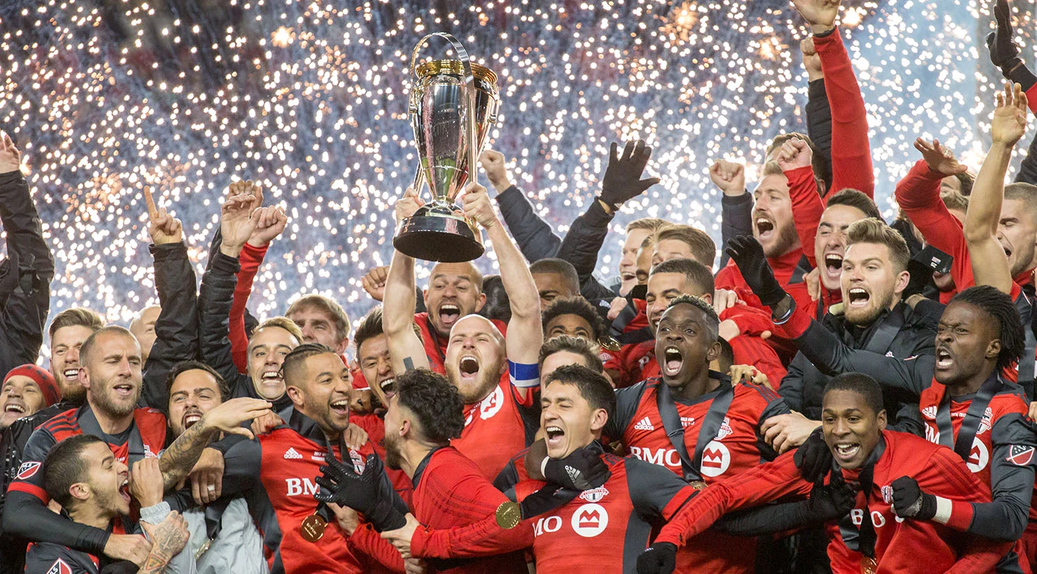 Sparks fly as the MLS Cup is finally lifted at BMO Field in 2017 after 11 seasons. Image by Dennis Marciniak of denMAR Media.