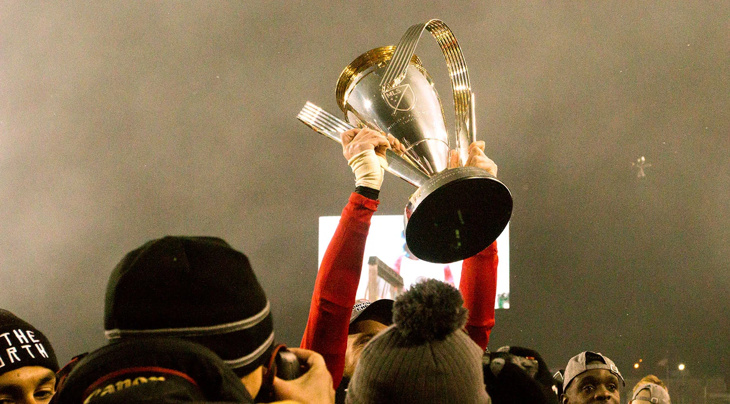 The trophy is lifted in the south end to celebrate the win for Toronto FC's 2017 MLS Cup win. Image by Dennis Marciniak of denMAR Media.