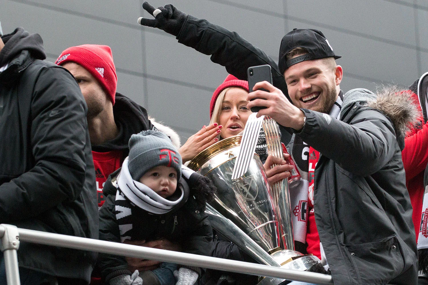 Toronto FC players celebrate with the trophy during the Toronto FC 2017 MLS Cup Parade. Image by Dennis Marciniak of Denmar Media.