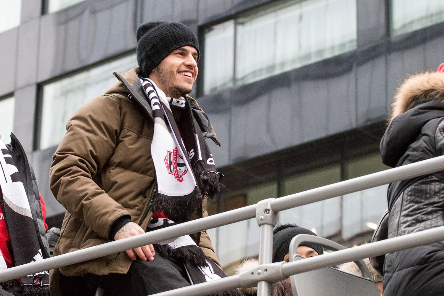 Sebastian Gioivnco attop the parade bus during the Toronto FC players celebrate with the trophy during the Toronto FC 2017 MLS Cup Parade. Image by Dennis Marciniak of Denmar Media.