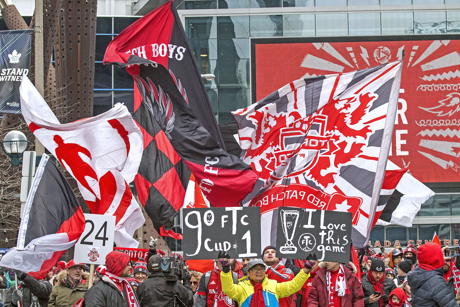 Toronto FC Supporter's march down the street during the Toronto FC 2017 MLS Cup Parade. Image by Dennis Marciniak of Denmar Media.