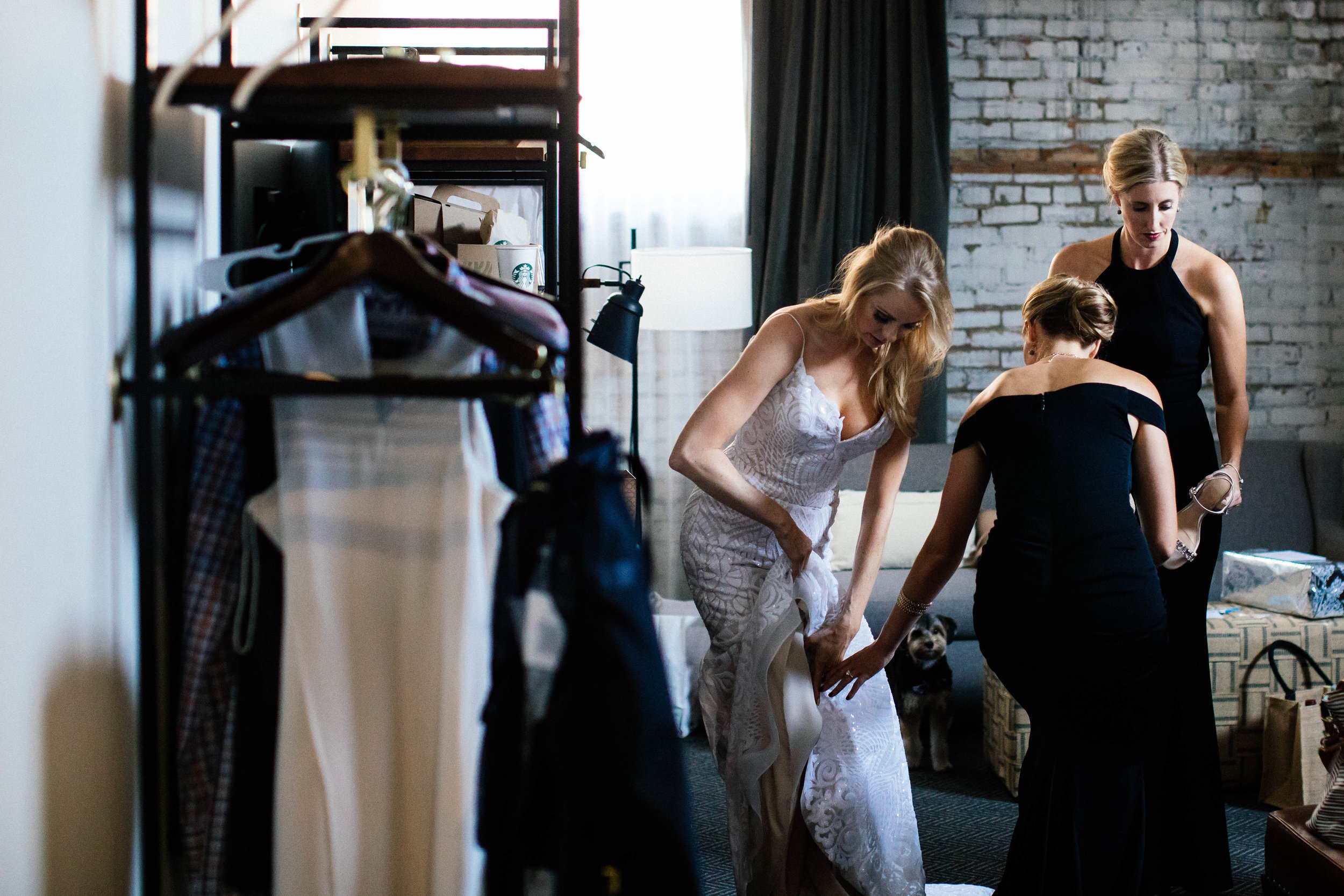 Hewing Hotel Wedding Photography Bridesmaids helping bride get ready