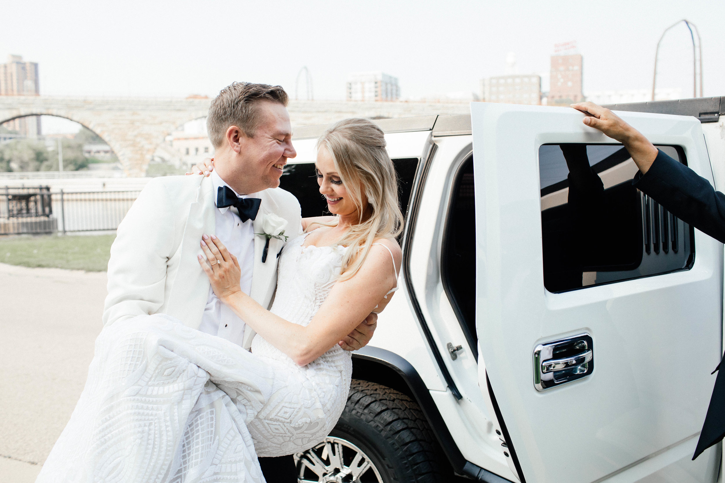 Hewing Hotel Wedding Photography groom helping bride into limo