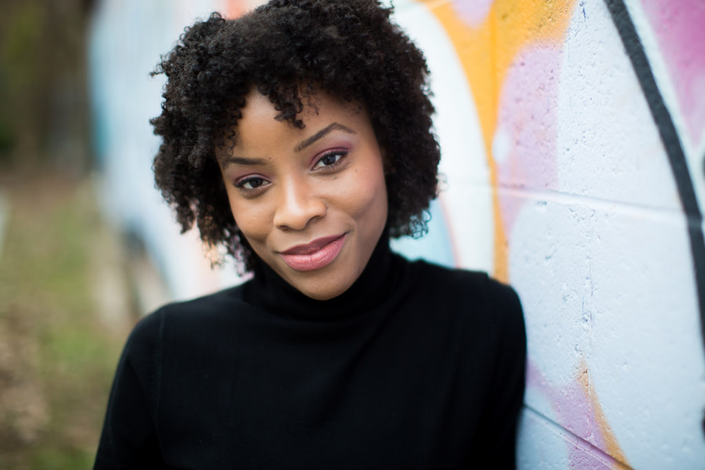 black woman in front of mural headshot