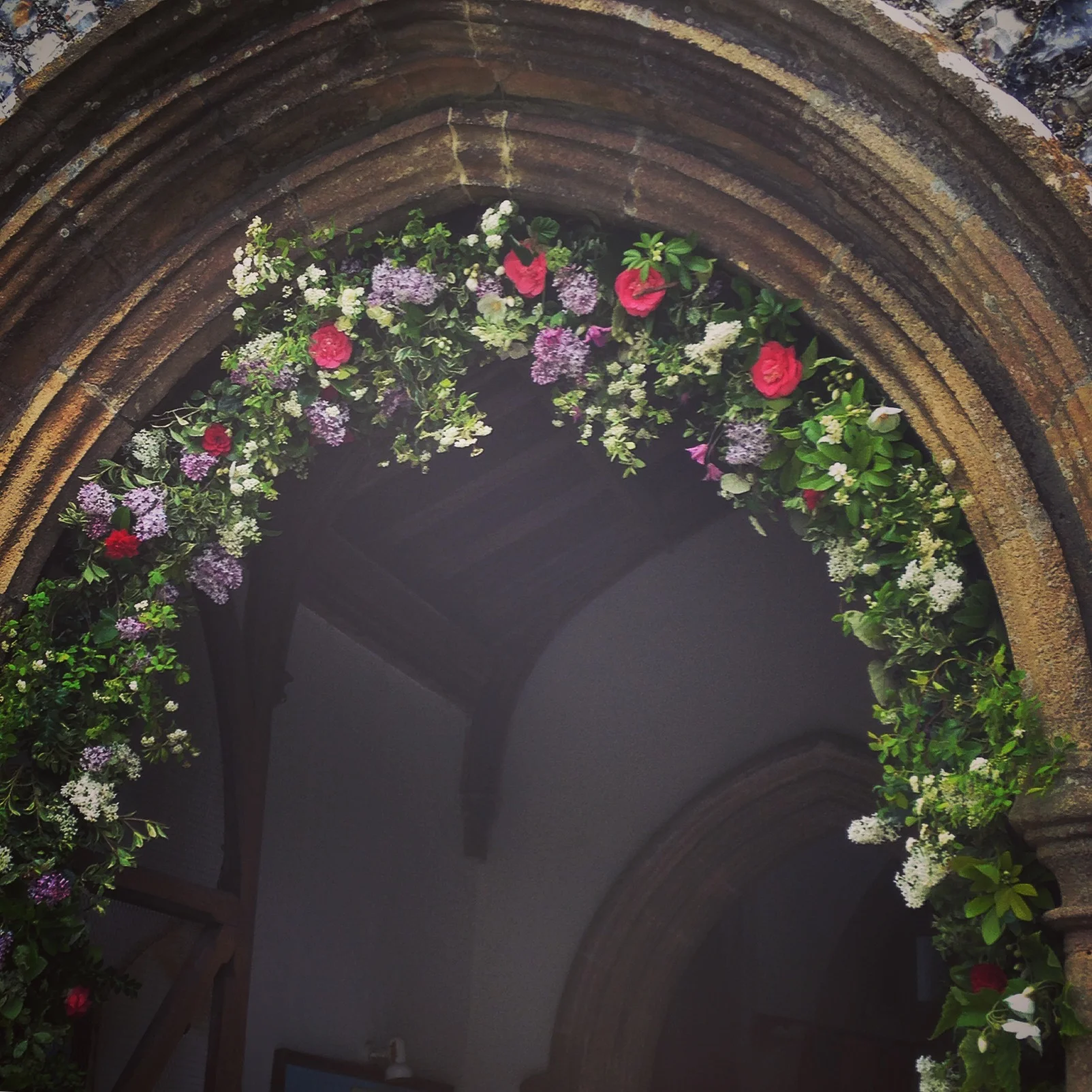 Spring wedding arch full of Lilac, Cemelias and Bridal wreath