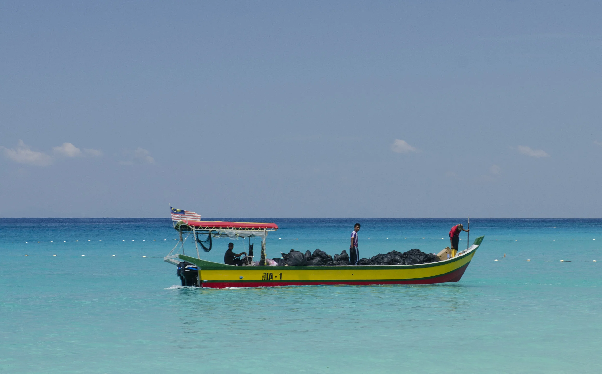 This boat came around regularly to pick up trash to haul to the mainland