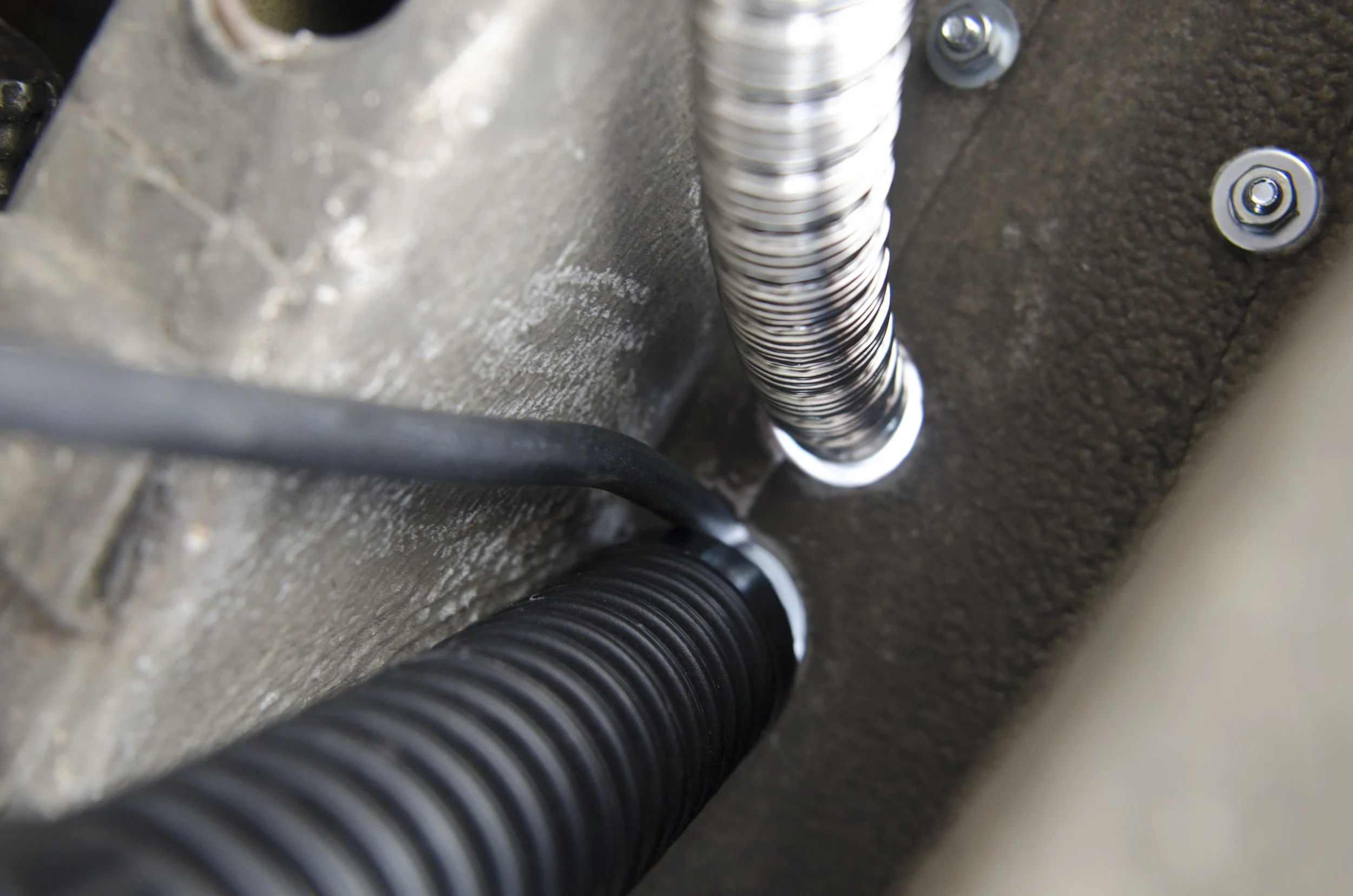 The intake and vent hoses on the underside of the vehicle