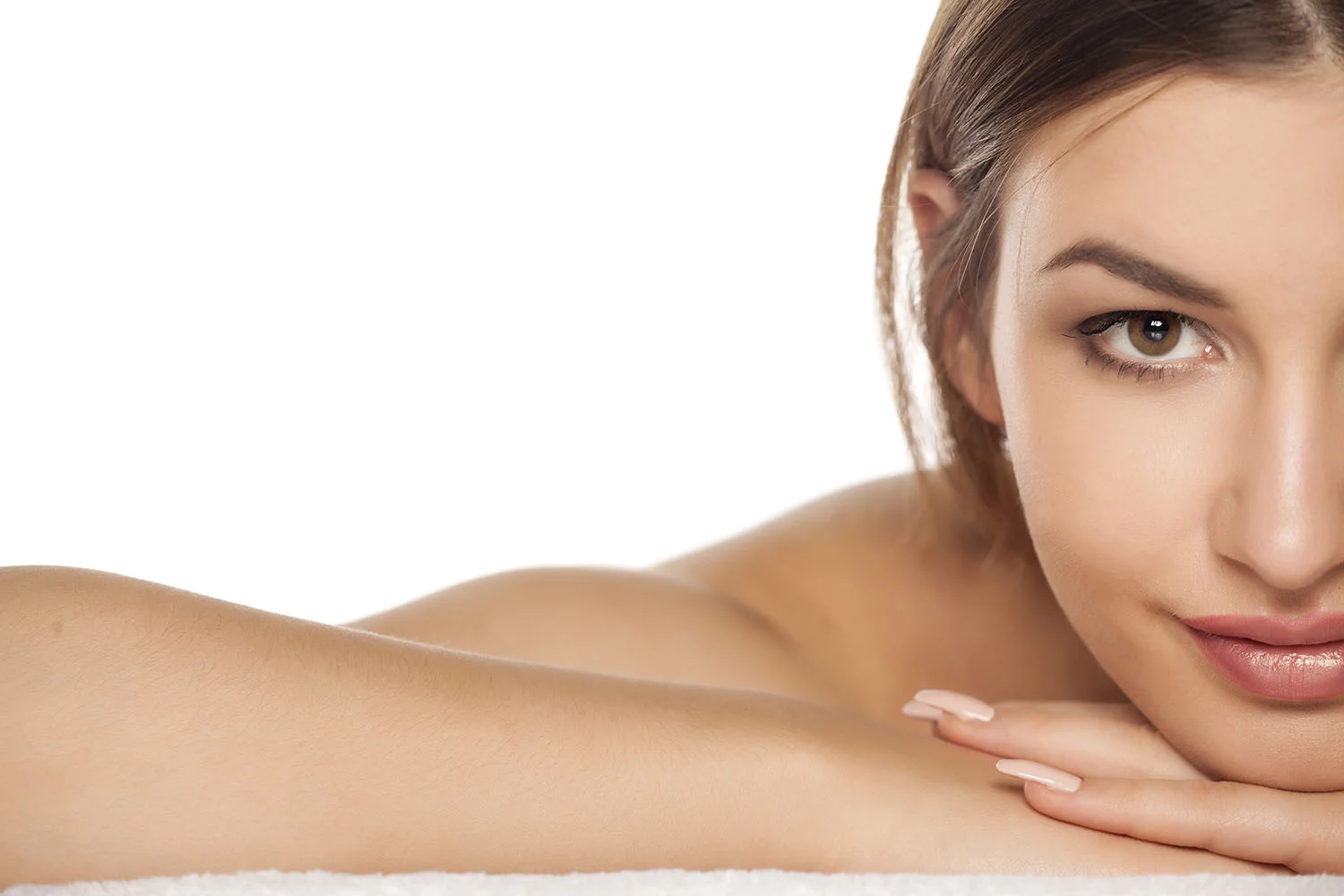 half portrait of a smiling young woman is lying down on towel.jpg