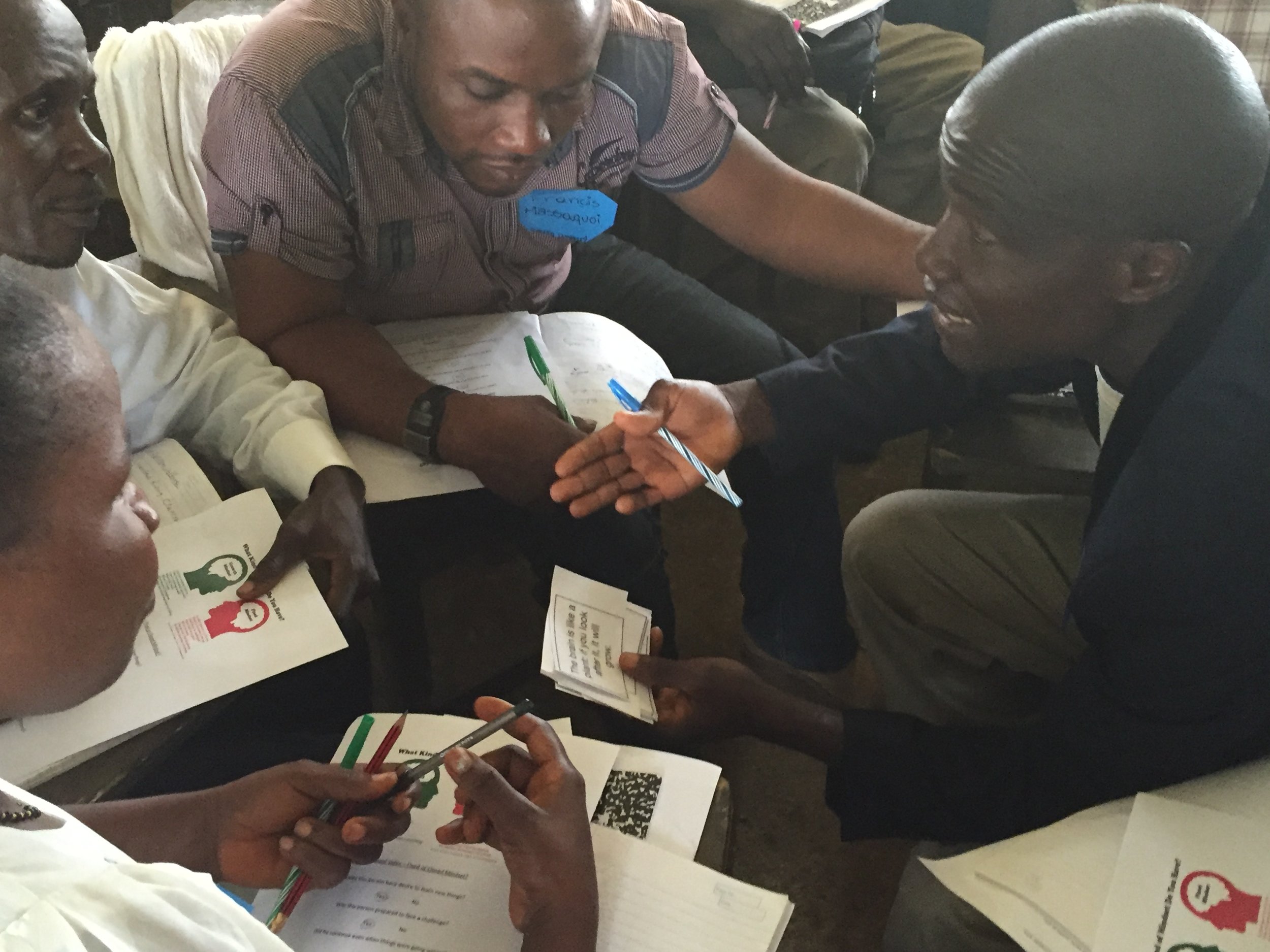 Teachers work through a card exercise during training