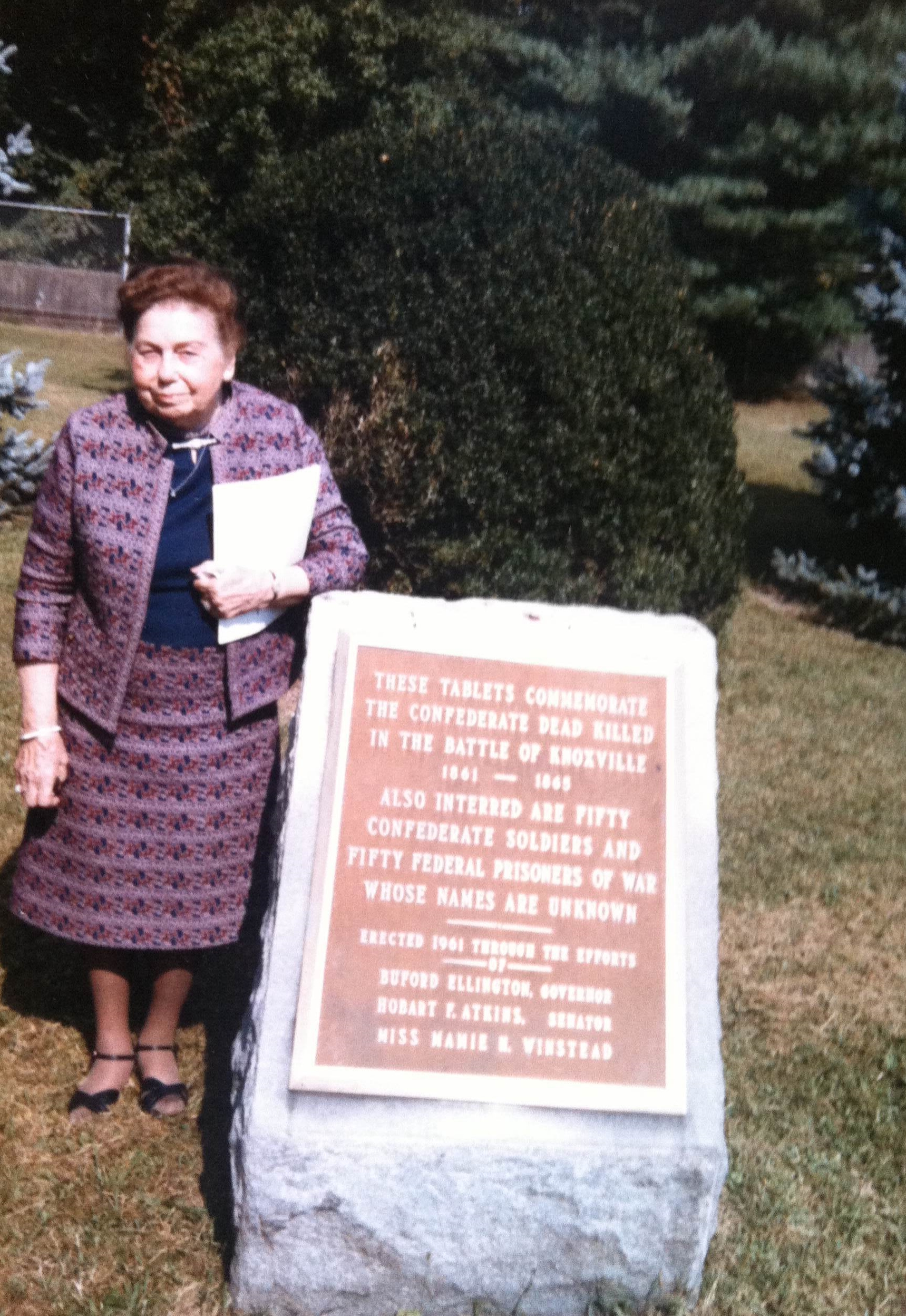 Mamie Winstead stands beside a commemorative plaque at Bethel Cemetery, 1985