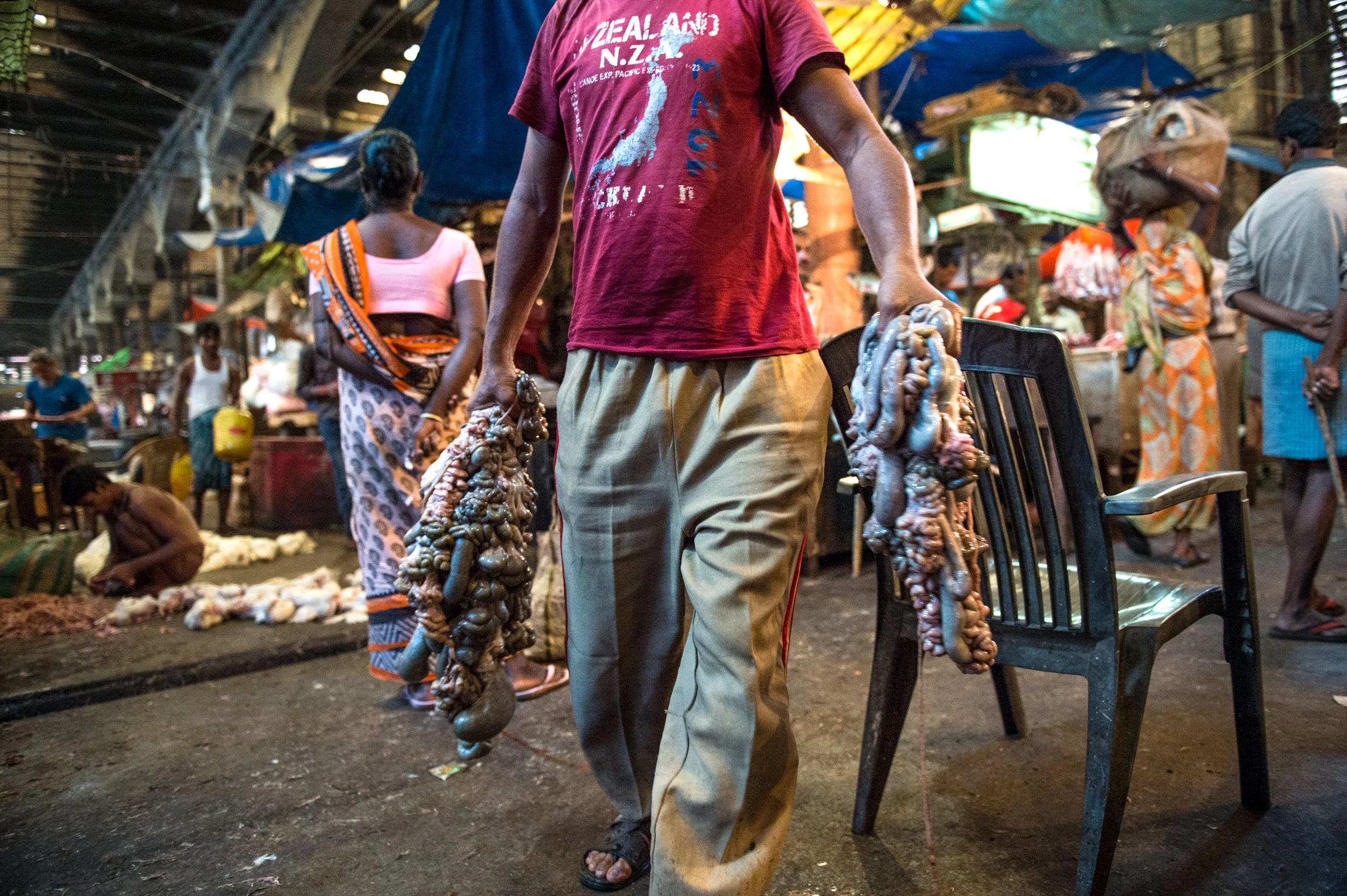 New Market Kolkata India slaughterhouse | A worker at the slaughterhouse, brings innards for further processing