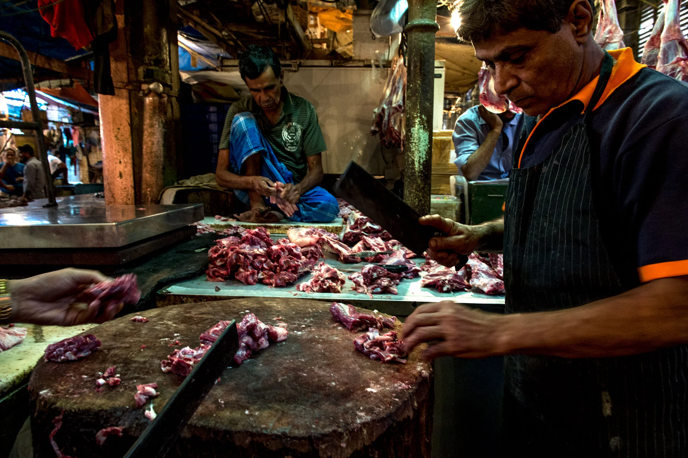 New Market Kolkata India slaughterhouse | Restaurant owner and chef, separating meat from the bone.