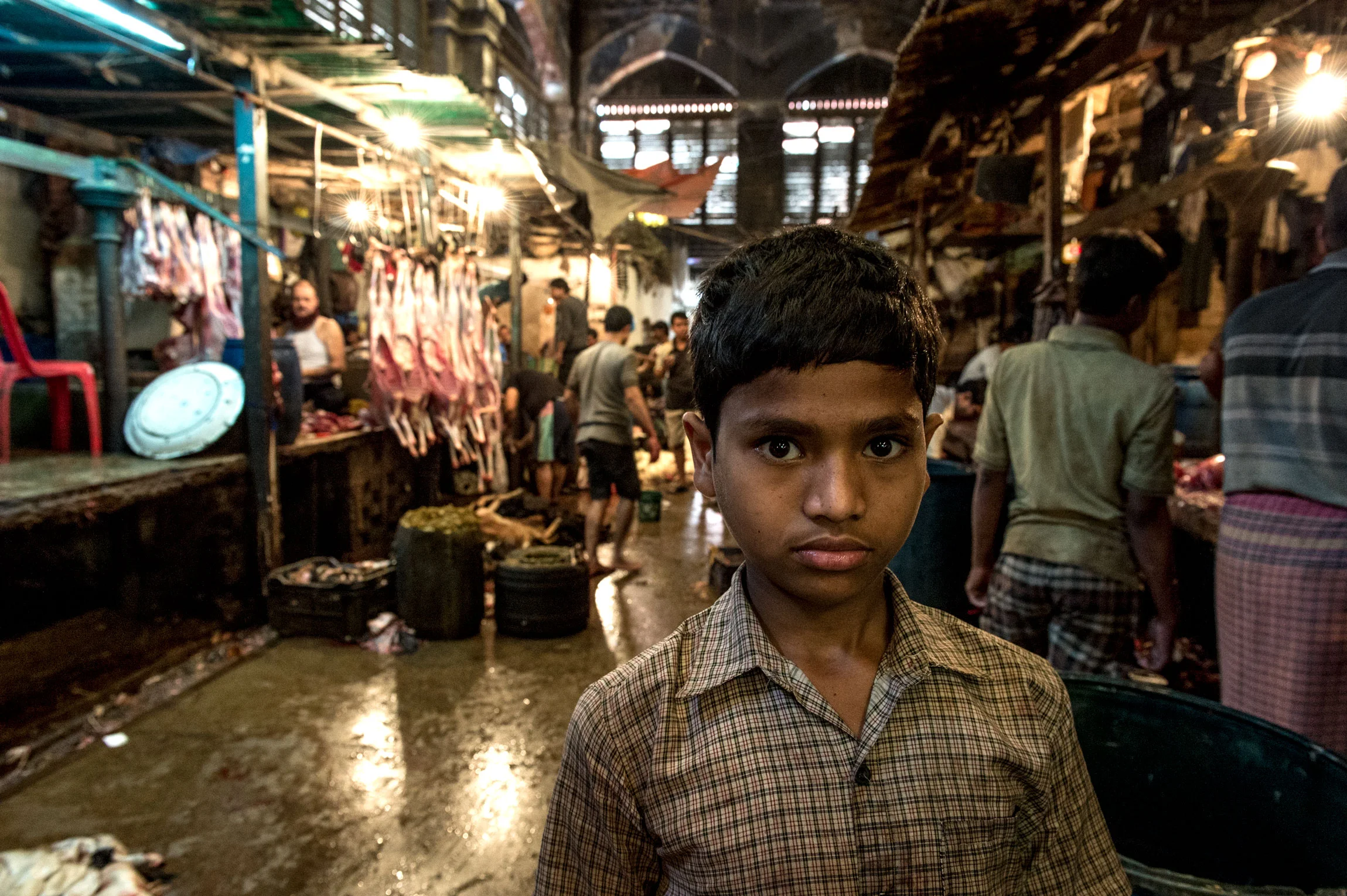 New Market Kolkata India slaughterhouse | a child worker posing in the meat hall of New Market.