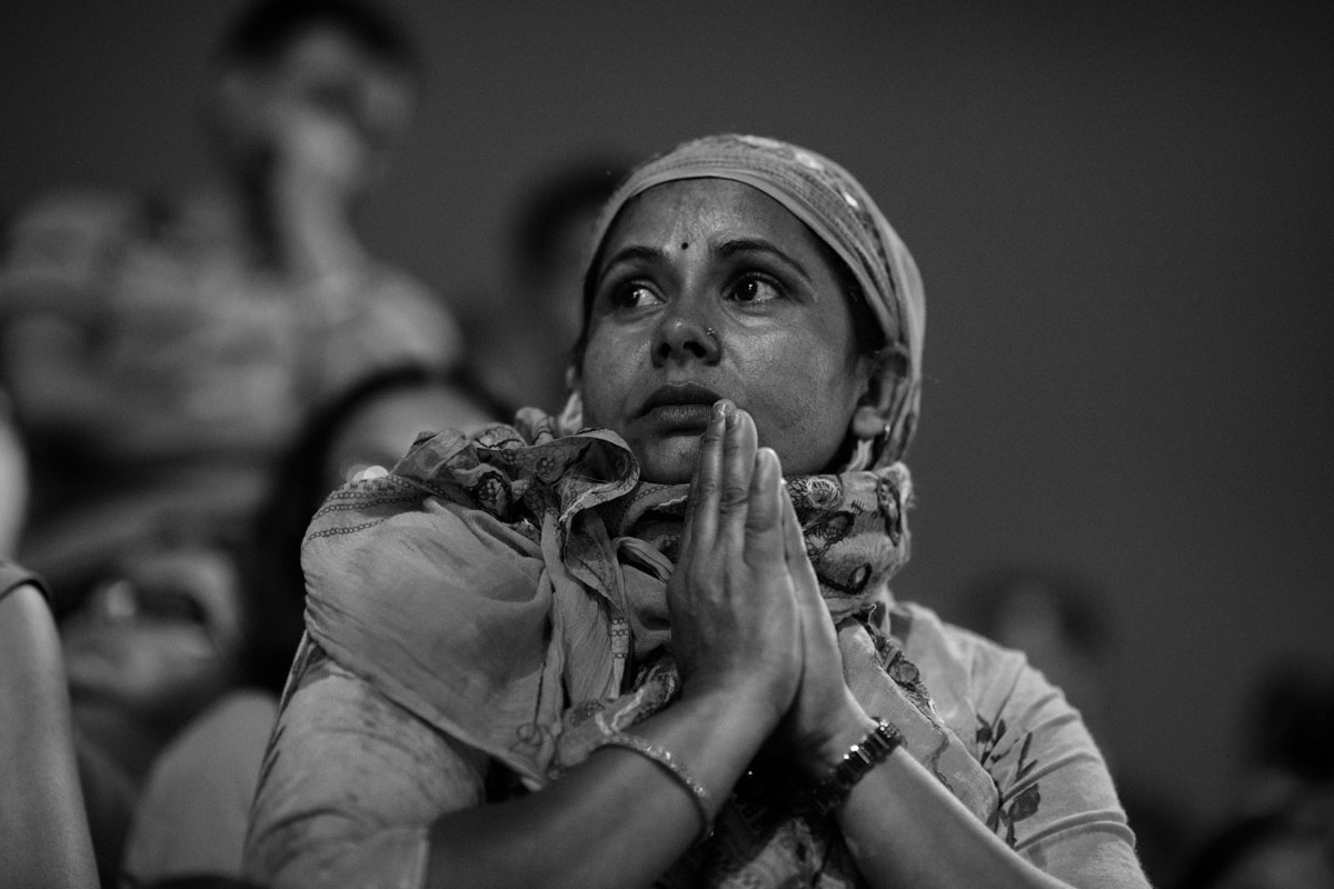 A devotee observing the Aarti. Aarti is a Hindu religious ritual of worship.