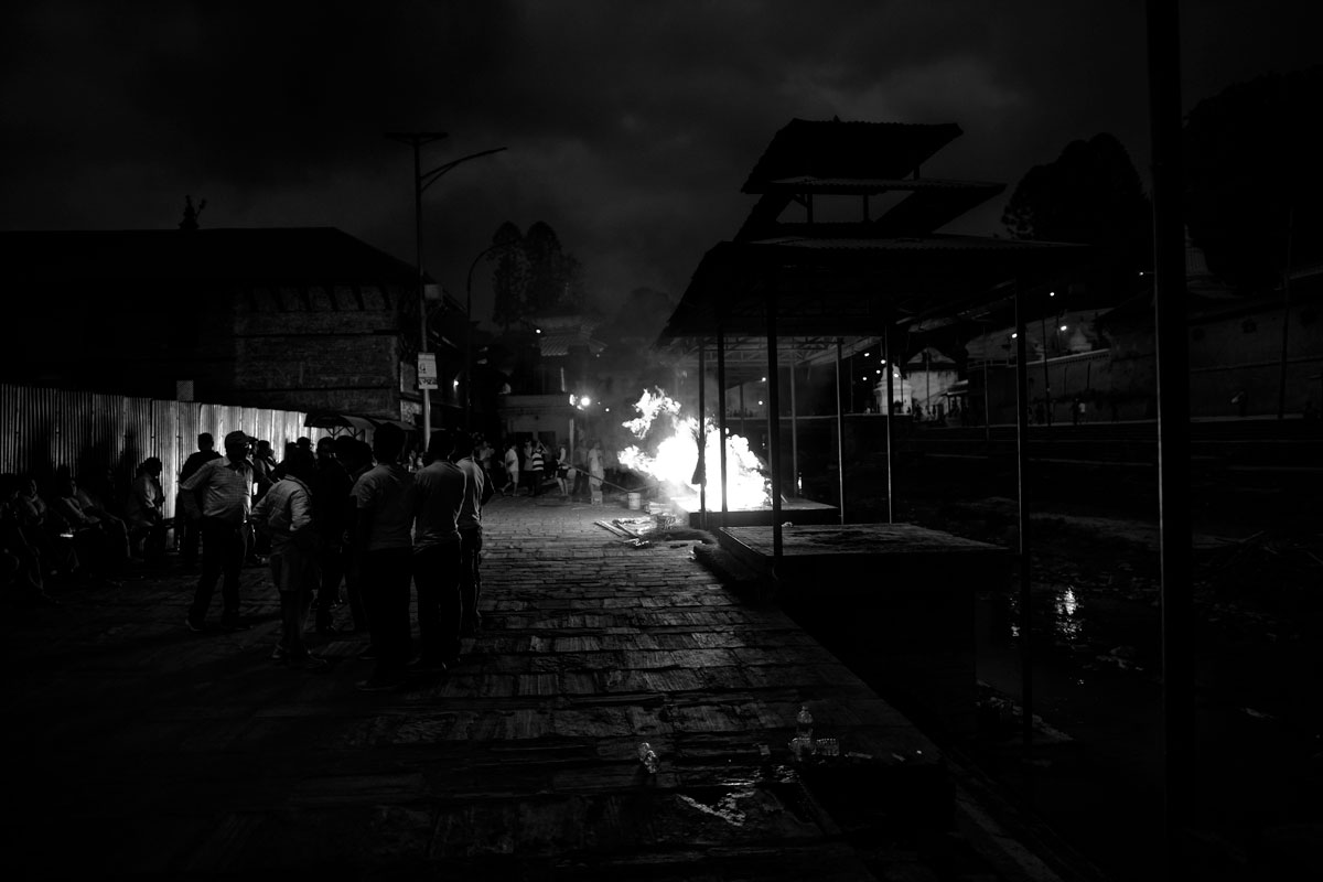 Antyeṣṭi, "last sacrifice" Pashupatinat, on the banks of the Bagmati River. Relatives of the deceased wait until the body is completely cremated.