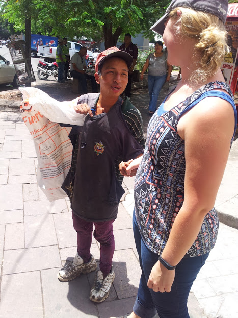On the right is Anna Carlson who is staff at Micah Project. On the left is the boy on the street who smells glue - his right hand is holding the bottle containing glue.