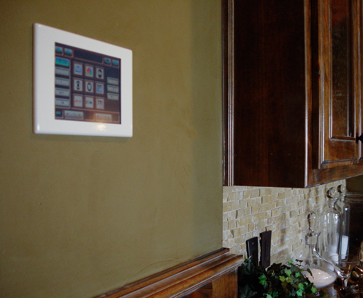 The Elan in-wall touchscreen controls audio and video, lighting, shades, and air conditioning