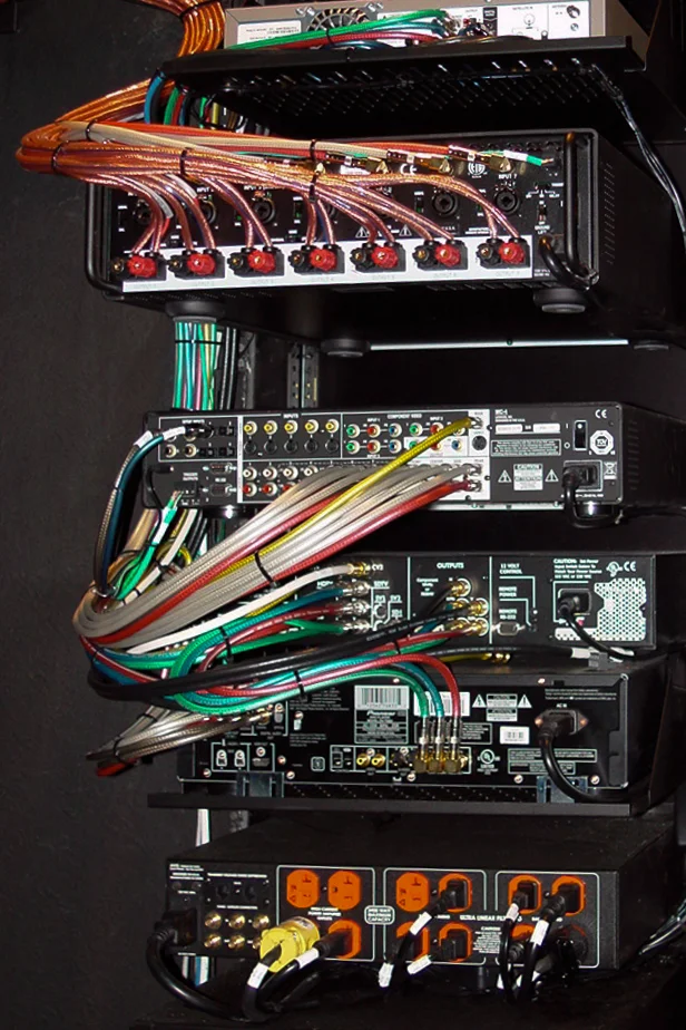 It's very important for our racks to be wired neatly. This is the back of a cinema room equipment rack. This 7.1 channel audio system is dressed with the copper wires at the top. The rack is small, and there are an incredible number of signal pathways—but all of it is manageable by correctly combing, color coding and labeling the wires. This careful attention to detail allows for higher levels of gear performance, and realistic technology upgrades over time. Our techs are extremely proud of the work they perform, even when it's on a rack that's not visible on a daily basis.