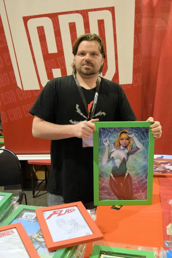 Dave Music showing a print in one of his frames.