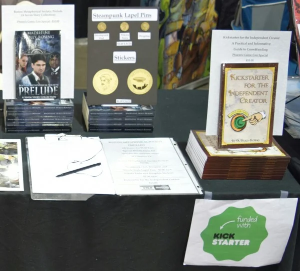 Novels, lapel pins, and stickers from Madeleine Holly-Rosing at Phoenix Comic Con 2016 (1).at Phoenix Comic Con 2016.