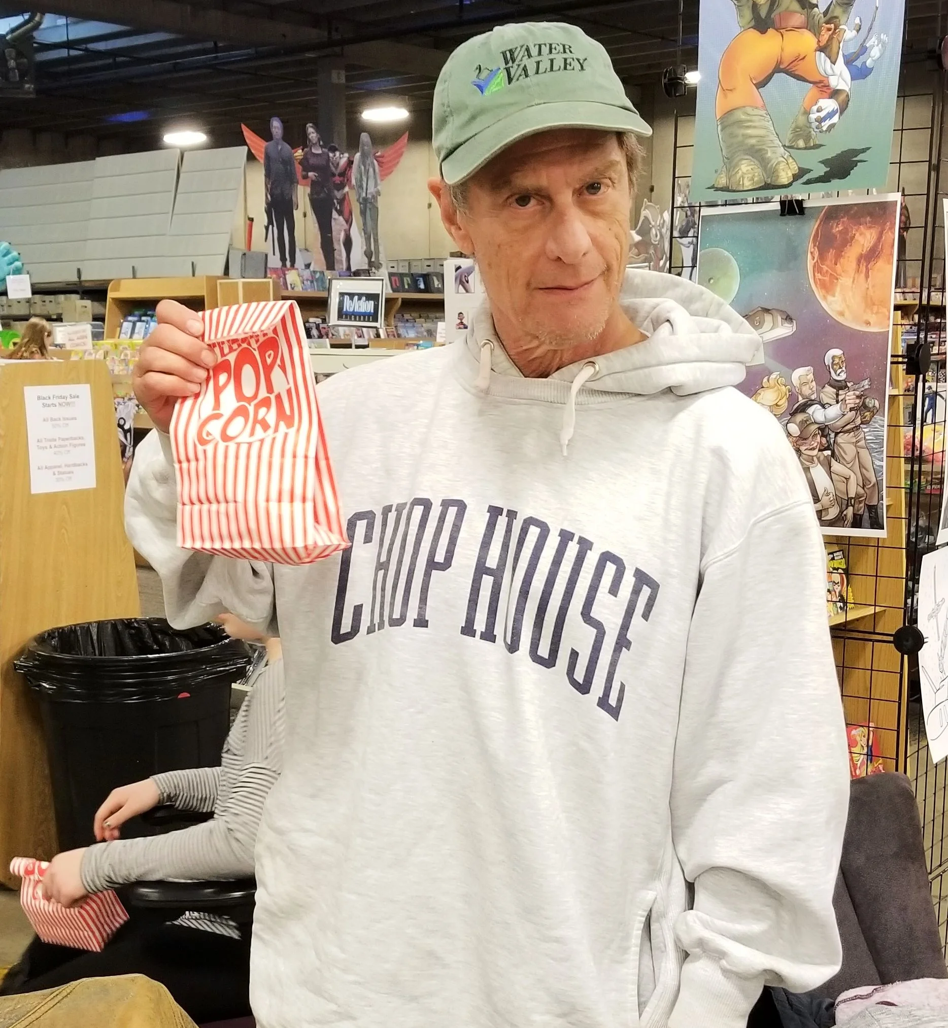Mike Baron (and his popcorn) at the Centennials launch party.