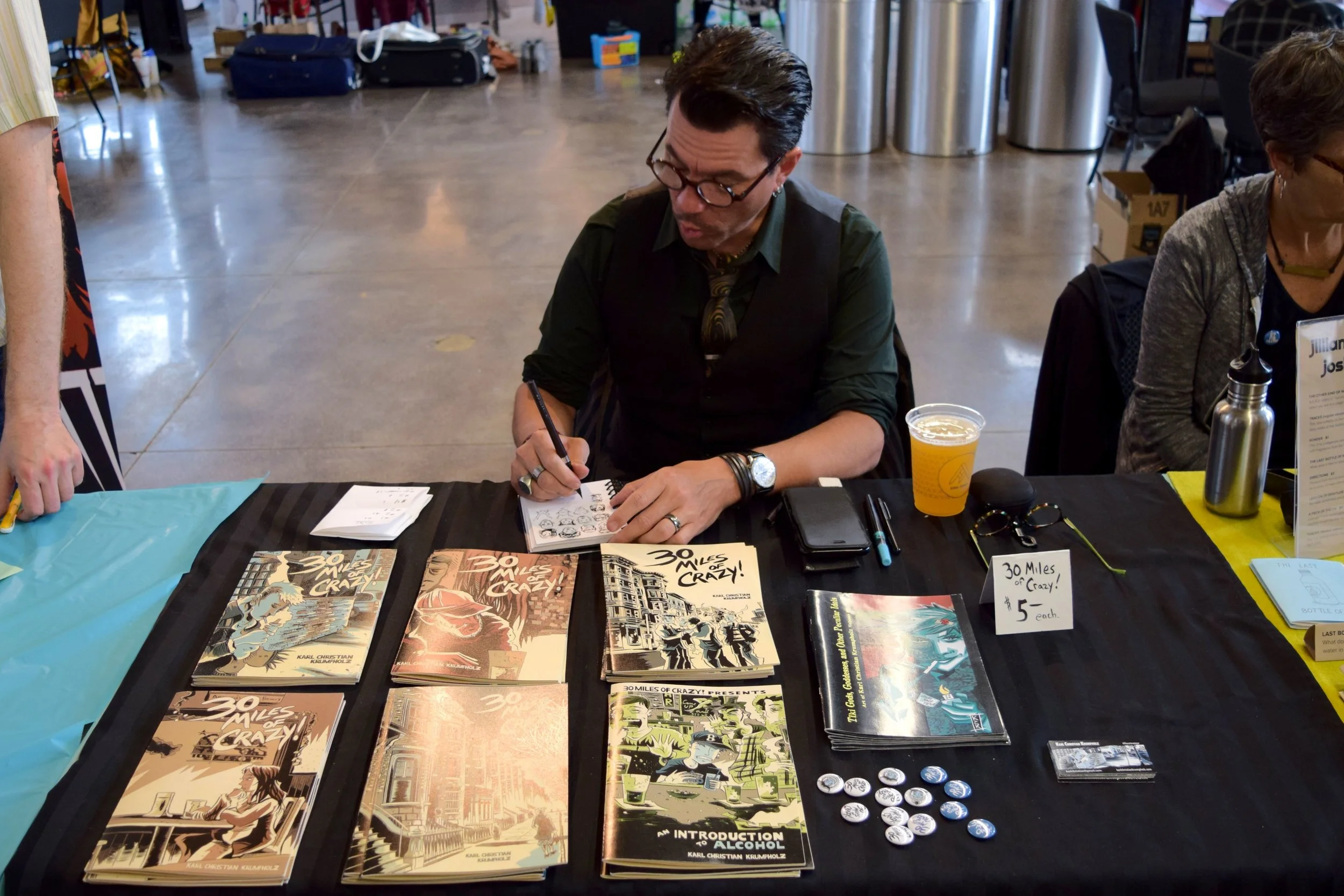 Karl Christian Krumpholz making silly faces at Denver Zine Fest 2018 .