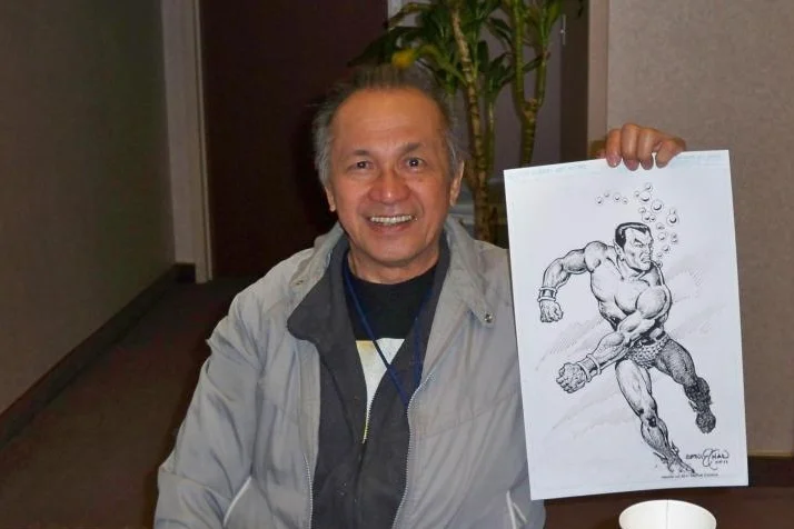 Ernie Chan holds up a Namor commission.
