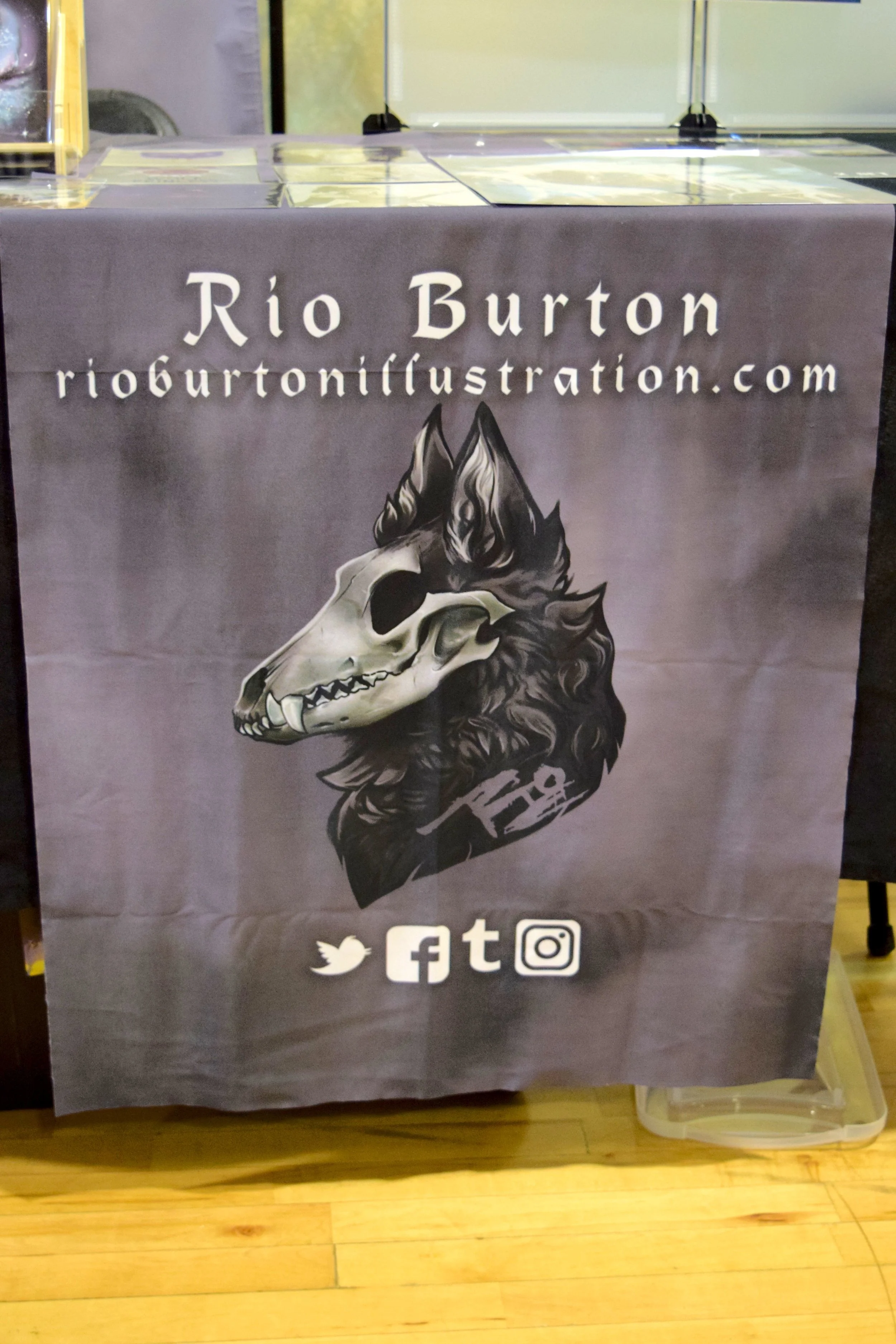 Rio Burton’s table banner at Fort Collins Comic Con 2018.