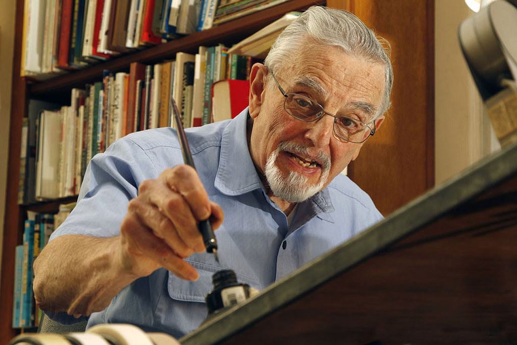 Hy Eisman at his drawing table.