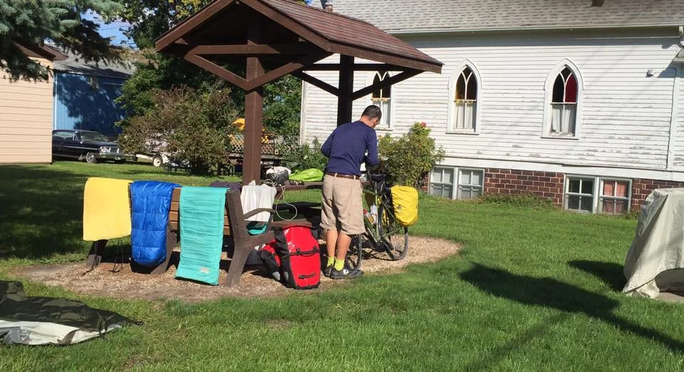 Dave fixed his flat and we aired out our gear under bright sunny skies. This little park was next to a church that long ago had exchanged services on Sunday for full time residential families. 
