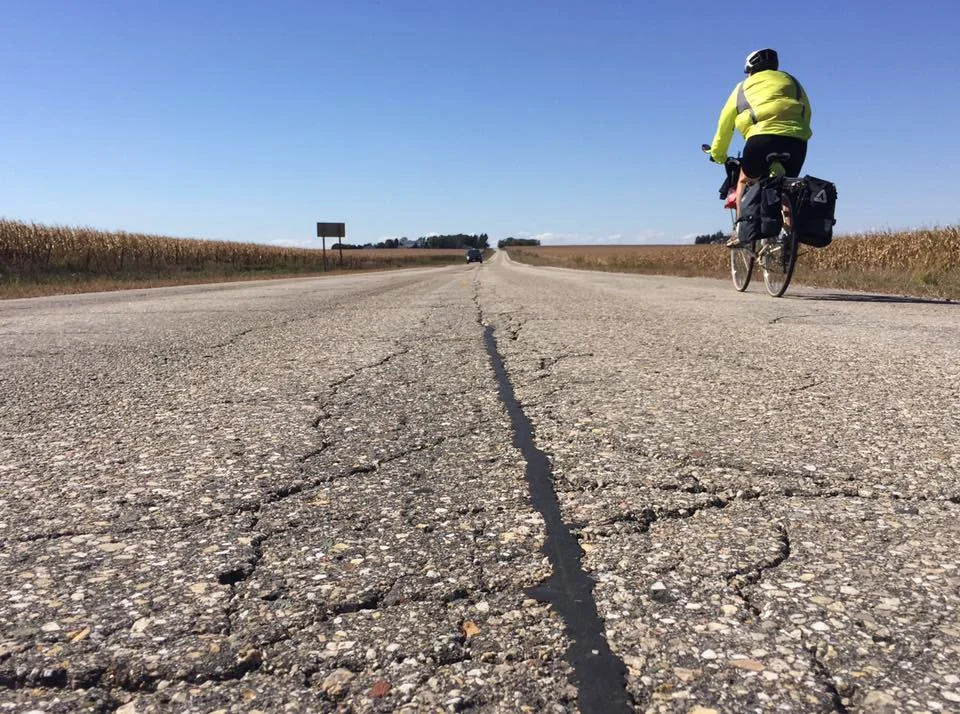 Dave was flat on his belly with camera in hand waiting for me to ride past so he could snap this shot. Obviously oblivious to the oncoming car which graciously rolled around him lying in the middle of the road. I am loving these flat roads!