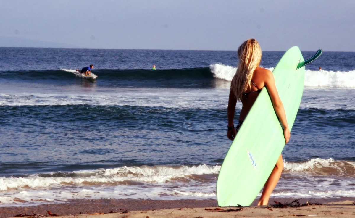 blond girl surfer looking at surfer.jpg